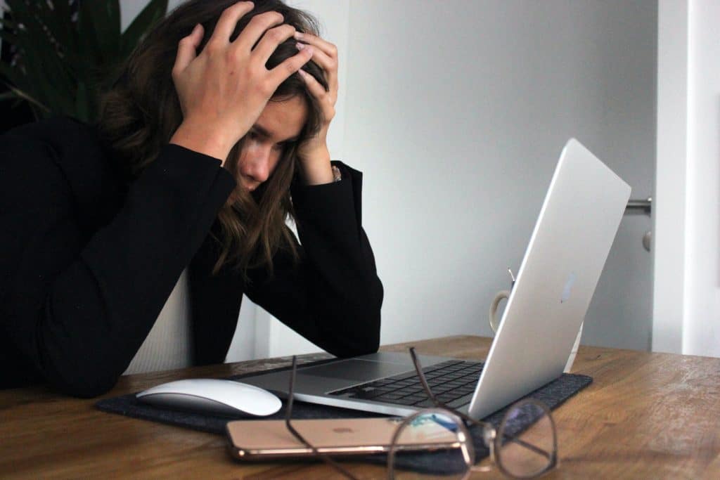 woman stressed at computer from wrongful dismissal