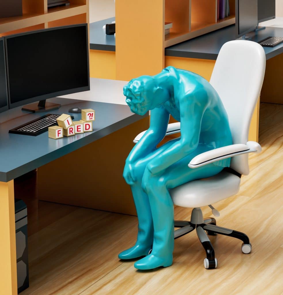 sitting at computer after wrongful dismissal